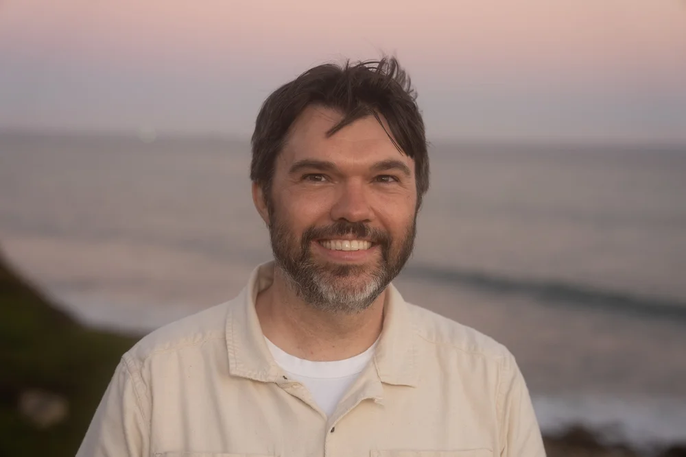 Gabe Thorburn at the coast at sunset